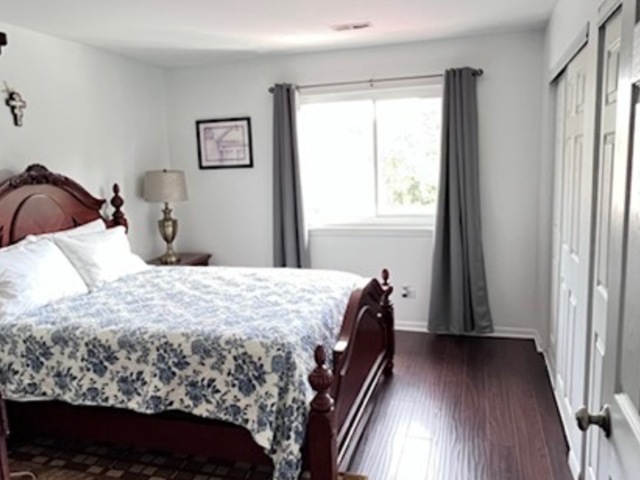 920 South Plum Grove Road, Unit 225 Palatine, IL 60067 - Photo 10 of 15 a bedroom with a bed and a window