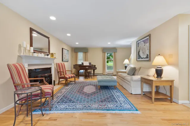 a living room with furniture a fireplace and a table