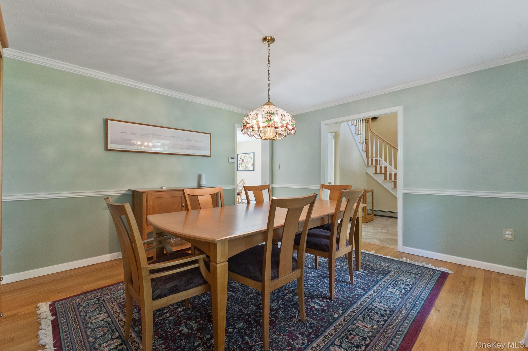 9 Windswept Circle Brewster, NY 10509 - Photo 22 of 43 a dining room with furniture a chandelier and wooden floor