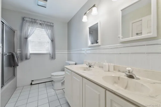 a bathroom with a sink toilet and mirror