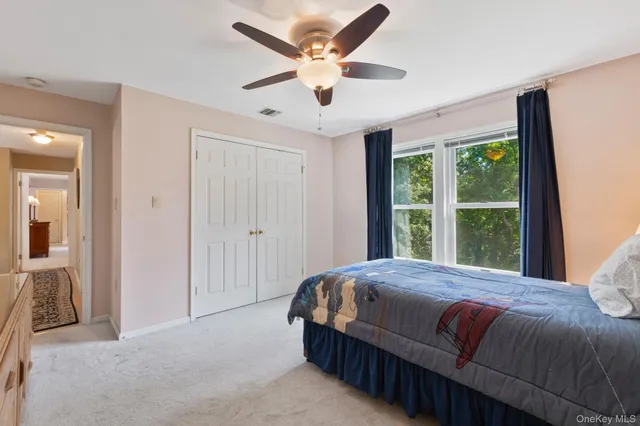 a bedroom with a large bed and a large window