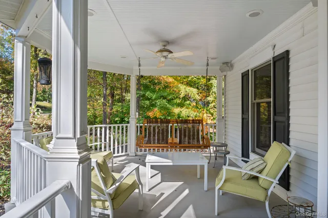 a view of a patio with a table chairs and a porch