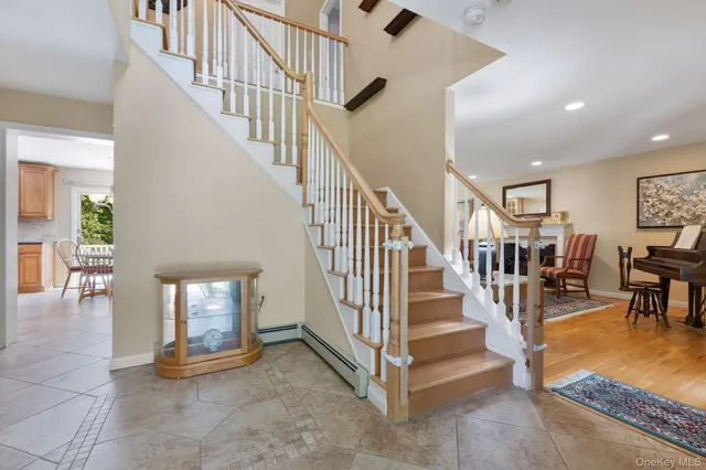 a view of entryway and hall with dining room and stairs