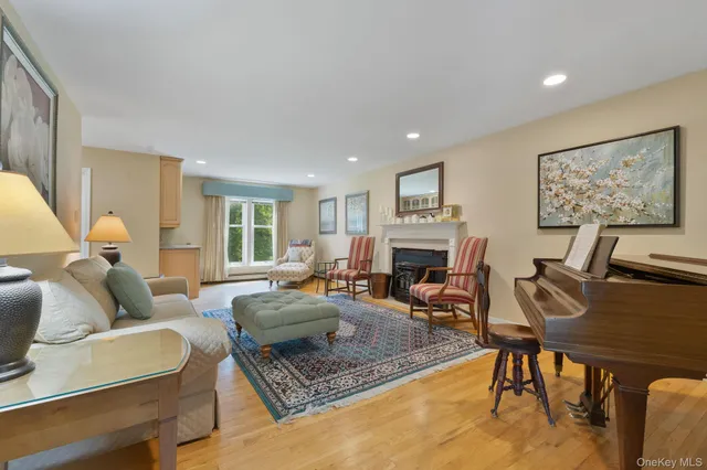 a living room with furniture a fireplace and a table
