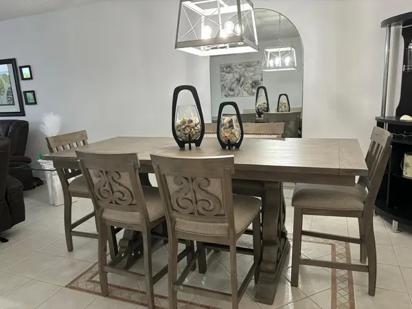 a view of a dining room with furniture and a chandelier