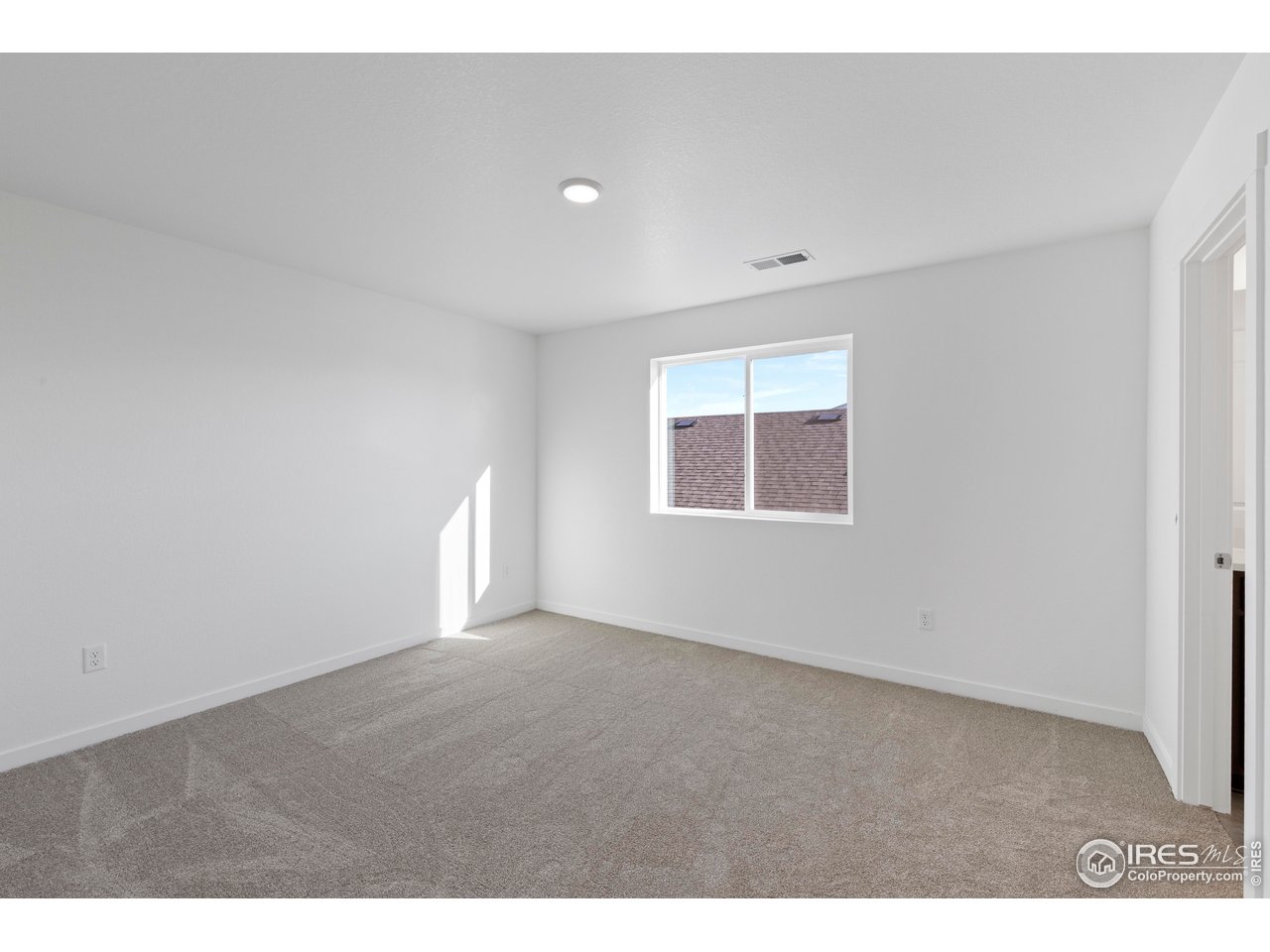 1472 Boyle Street Windsor, CO 80550 - Photo 21 of 25 a view of an empty room with a window