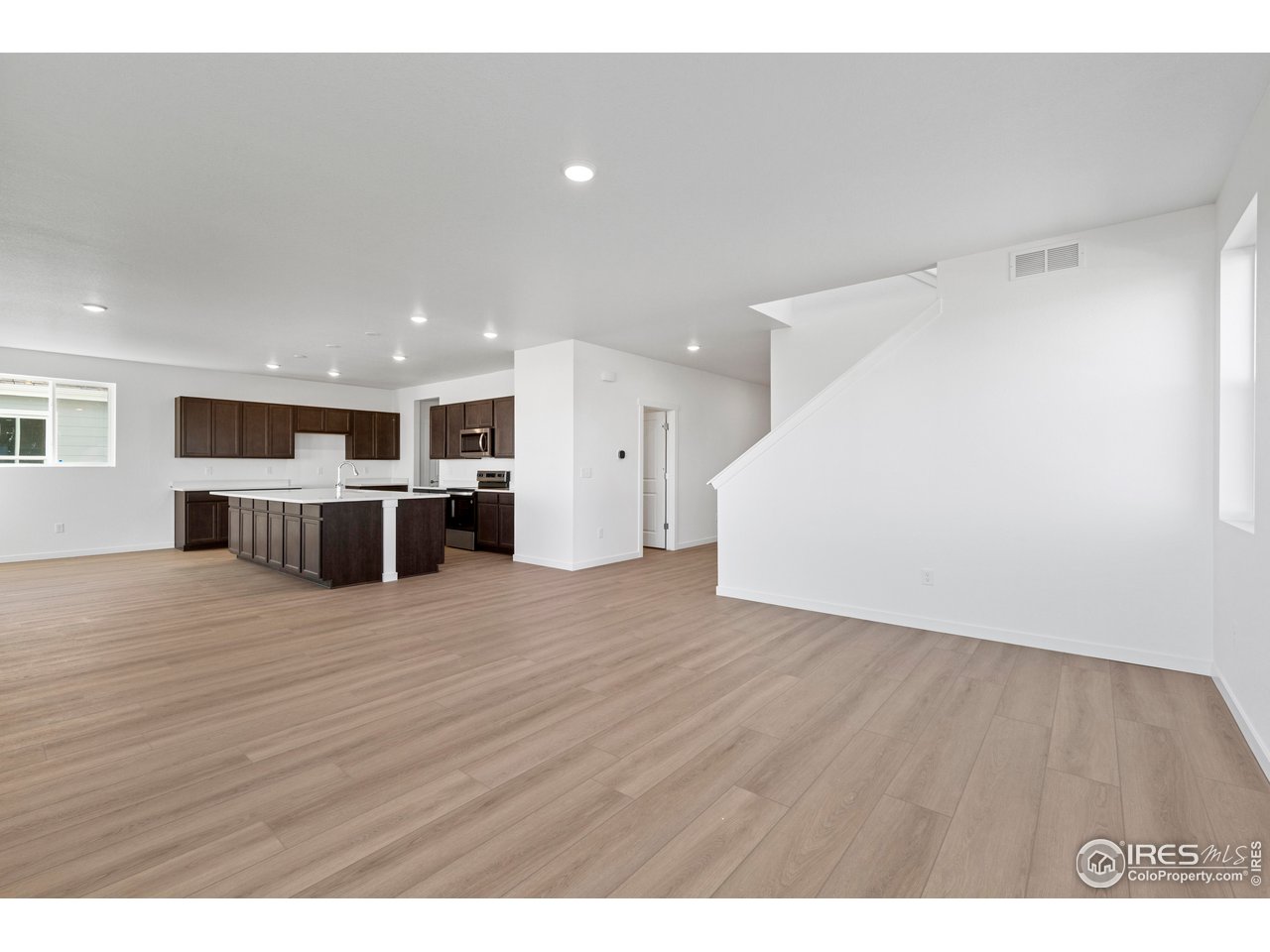 1472 Boyle Street Windsor, CO 80550 - Photo 3 of 25 a view of kitchen and wooden floor