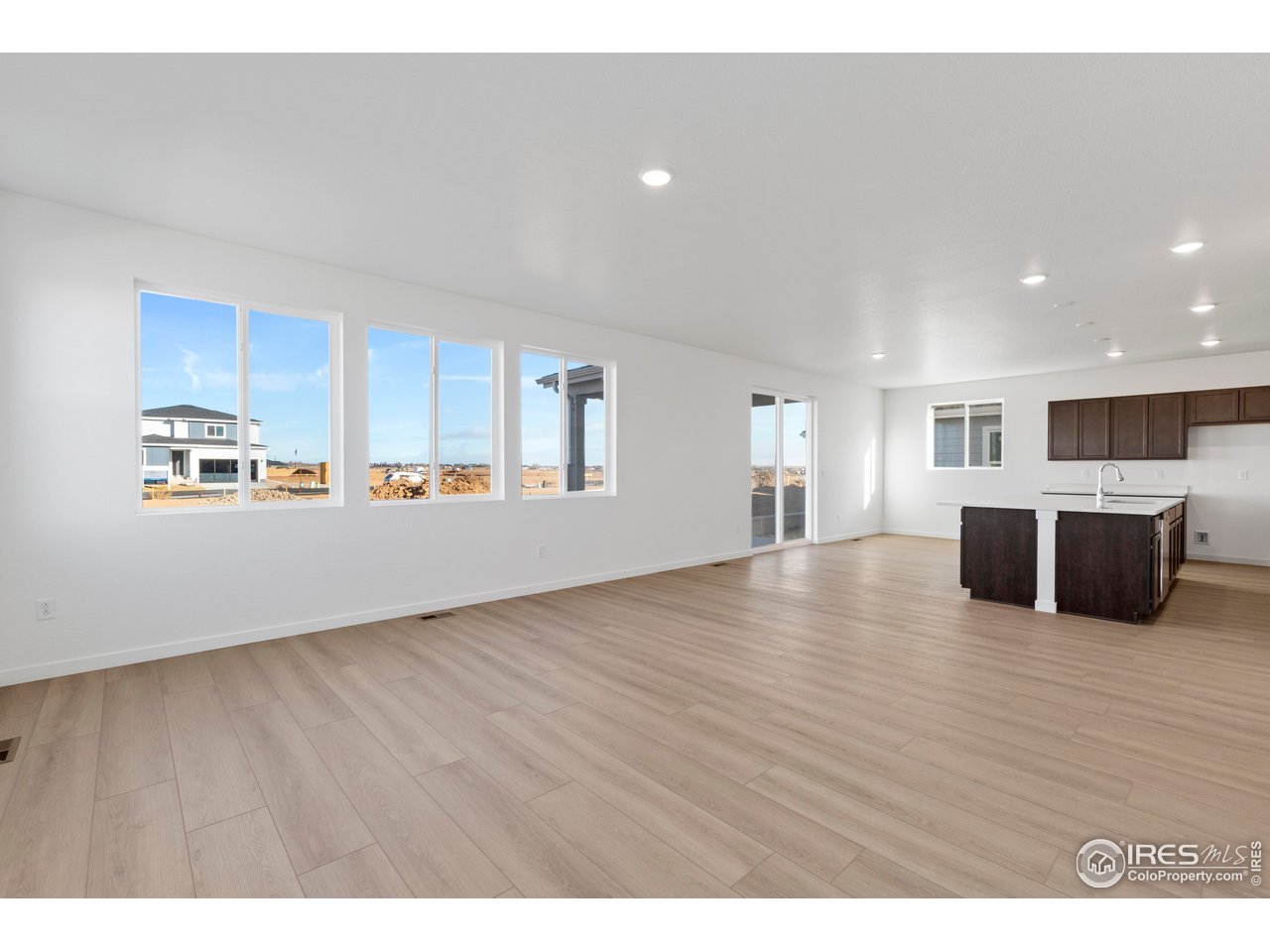 1472 Boyle Street Windsor, CO 80550 - Photo 4 of 25 a view of kitchen with stainless steel appliances granite countertop a refrigerator and a wooden floors