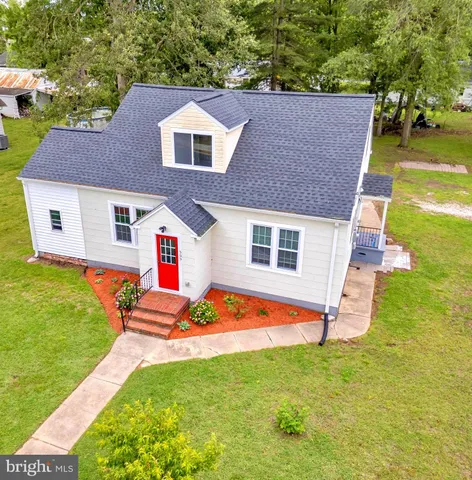a aerial view of a house with swimming pool yard and outdoor seating