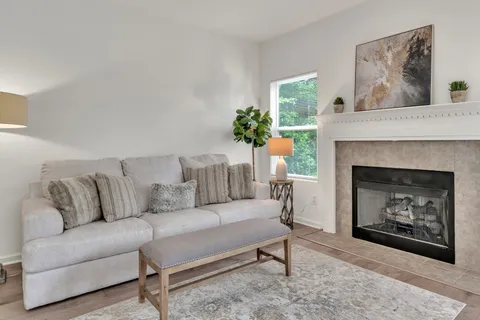 a living room with furniture and a fireplace