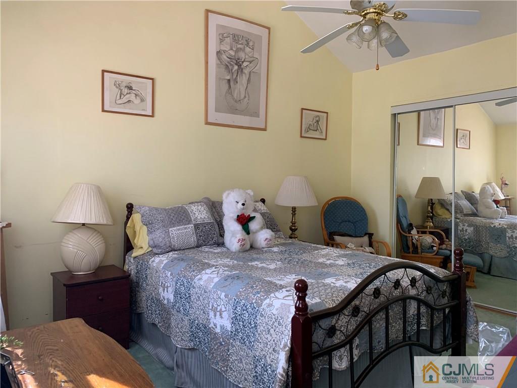 413 Harding Road Old Bridge, NJ 08879 - Photo 12 of 18 a bedroom with a bed and a chandelier