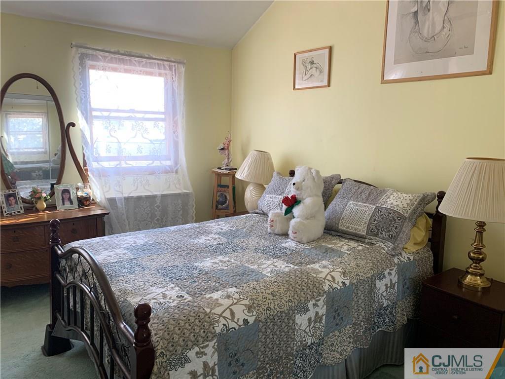 413 Harding Road Old Bridge, NJ 08879 - Photo 13 of 18 a bed sitting in a bedroom next to a window