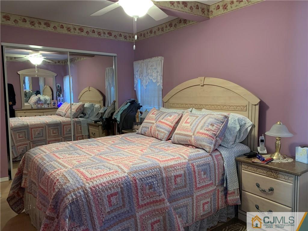 413 Harding Road Old Bridge, NJ 08879 - Photo 7 of 18 a bed room with a bed and a chandelier