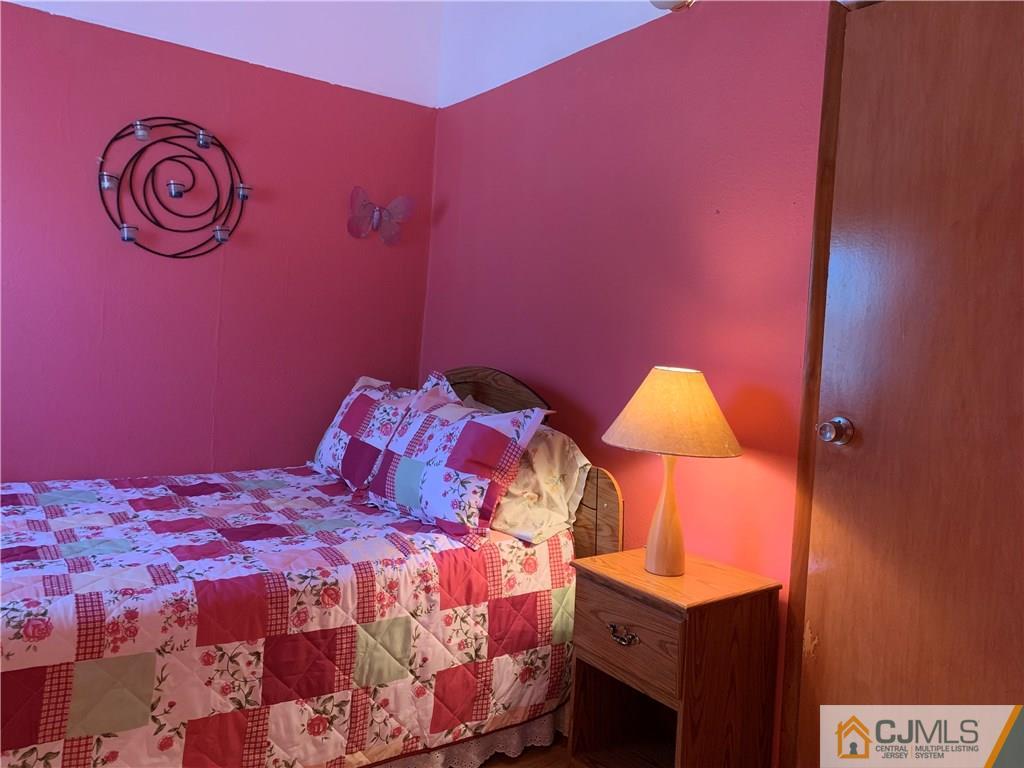 413 Harding Road Old Bridge, NJ 08879 - Photo 10 of 18 a bedroom with a bed and a lamp