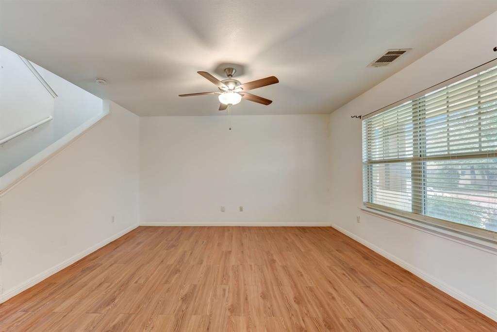 4502 Kind Way Austin, TX 78725 - Photo 4 of 13 Spare room with a ceiling fan and light wood-style floors