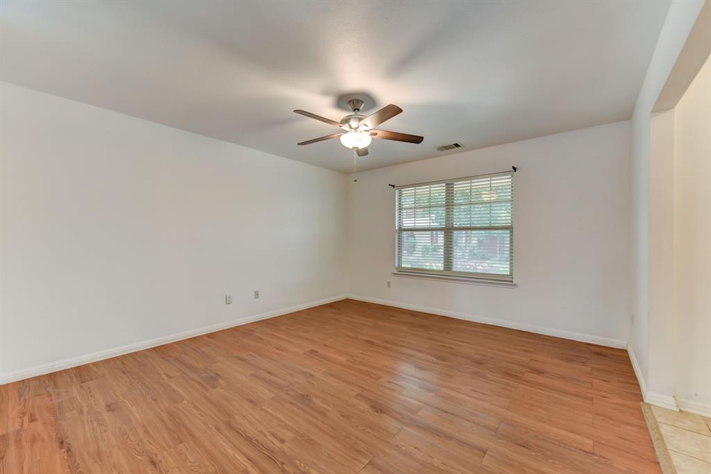4502 Kind Way Austin, TX 78725 - Photo 5 of 13 Unfurnished room featuring light wood-style flooring and a ceiling fan