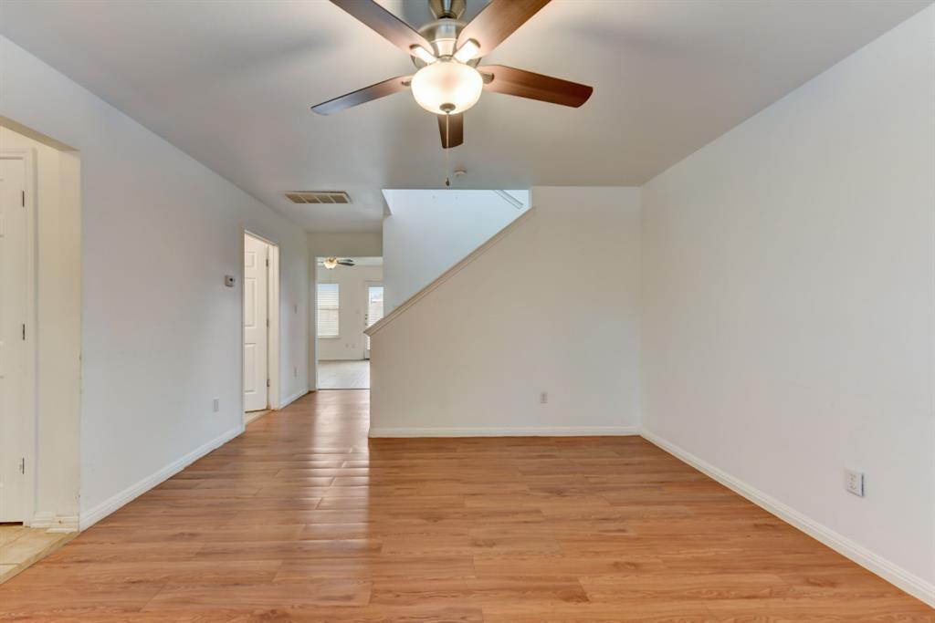4502 Kind Way Austin, TX 78725 - Photo 6 of 13 Unfurnished living room with light wood-style floors and a ceiling fan