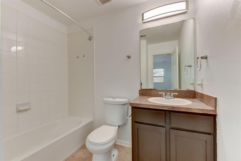 4502 Kind Way Austin, TX 78725 - Photo 9 of 13 Full bathroom with vanity, tub / shower combination, and light tile patterned floors