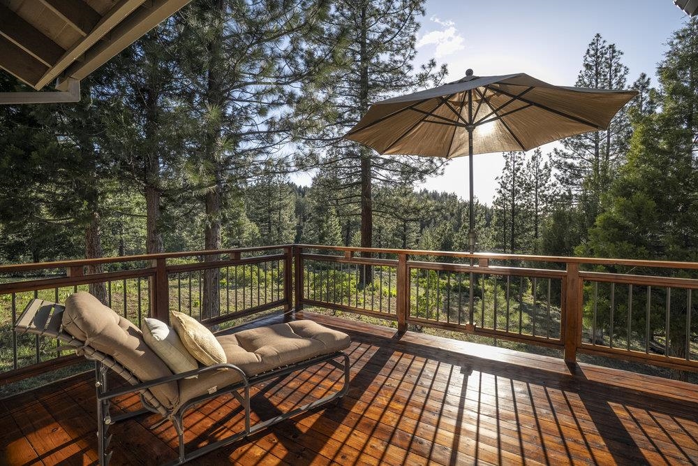238 Clouds Rest Portola, CA 96122 - Photo 15 of 34 a view of a balcony with wooden floor and umbrella