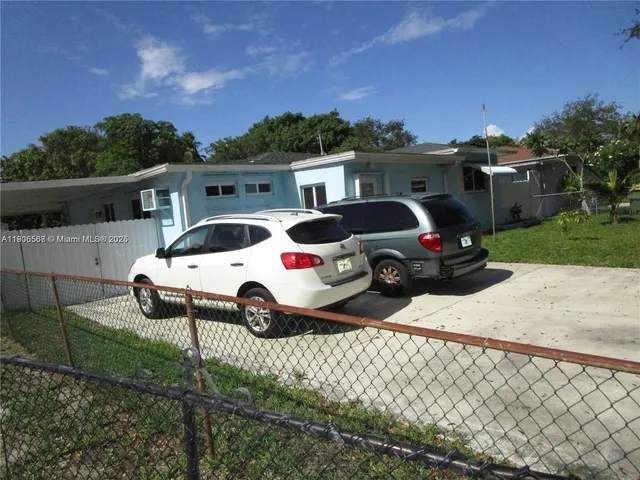 a view of a house with backyard porch and sitting area