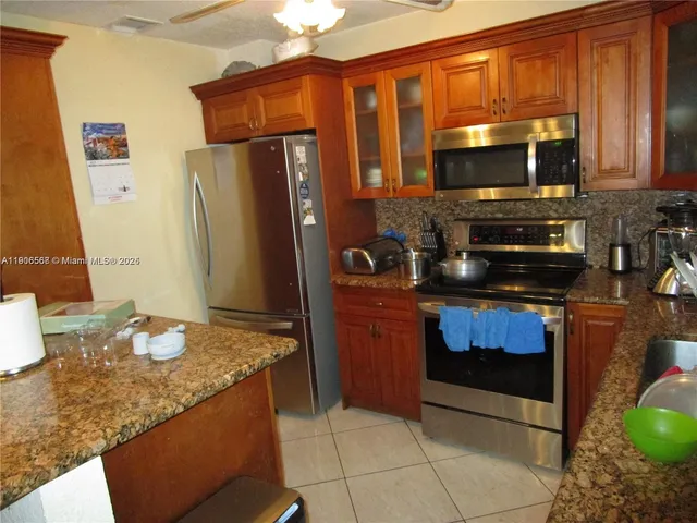 a kitchen with a stove a sink and a microwave