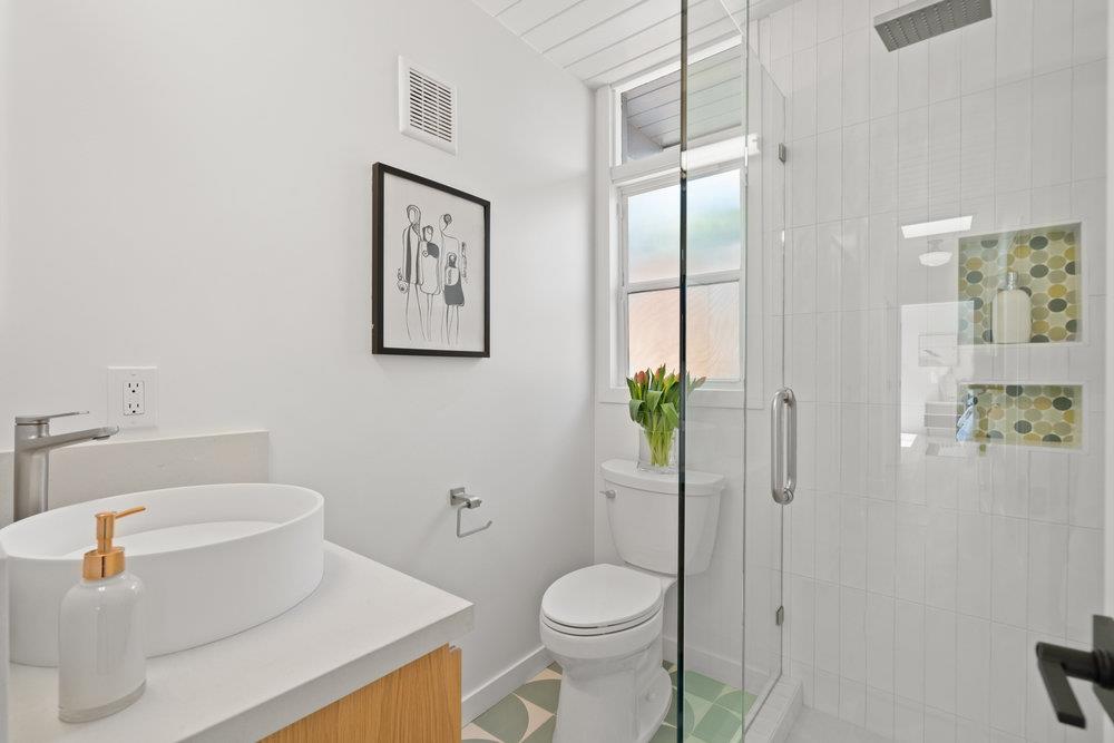 1669 Eleanor Drive San Mateo, CA 94402 - Photo 19 of 31 a white toilet sitting next to a bathroom sink and a mirror