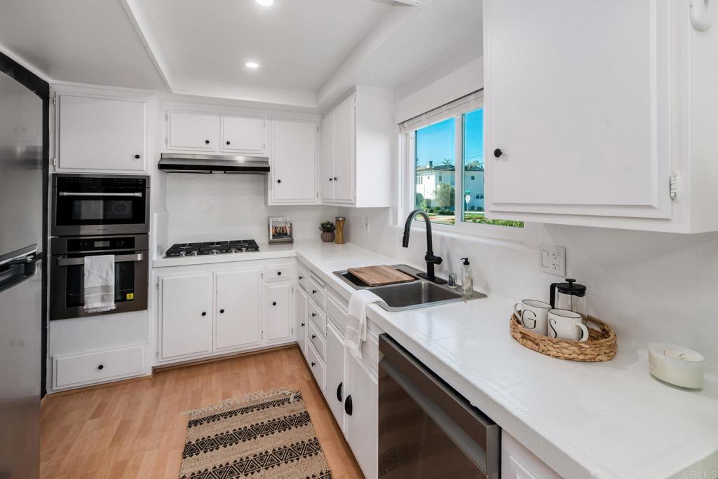 201 4th Street, Unit A/B Encinitas, CA 92024 - Photo 11 of 33 a kitchen with a sink appliances and cabinets