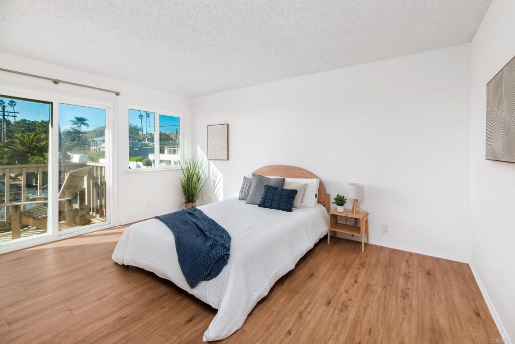 201 4th Street, Unit A/B Encinitas, CA 92024 - Photo 15 of 33 a bedroom with a bed and wooden floor
