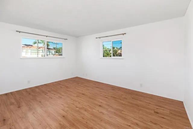 a view of a patio with table and chairs potted plants and wooden fence