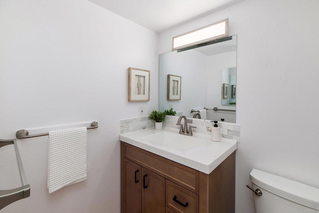 201 4th Street, Unit A/B Encinitas, CA 92024 - Photo 23 of 33 a bathroom with a sink toilet and mirror