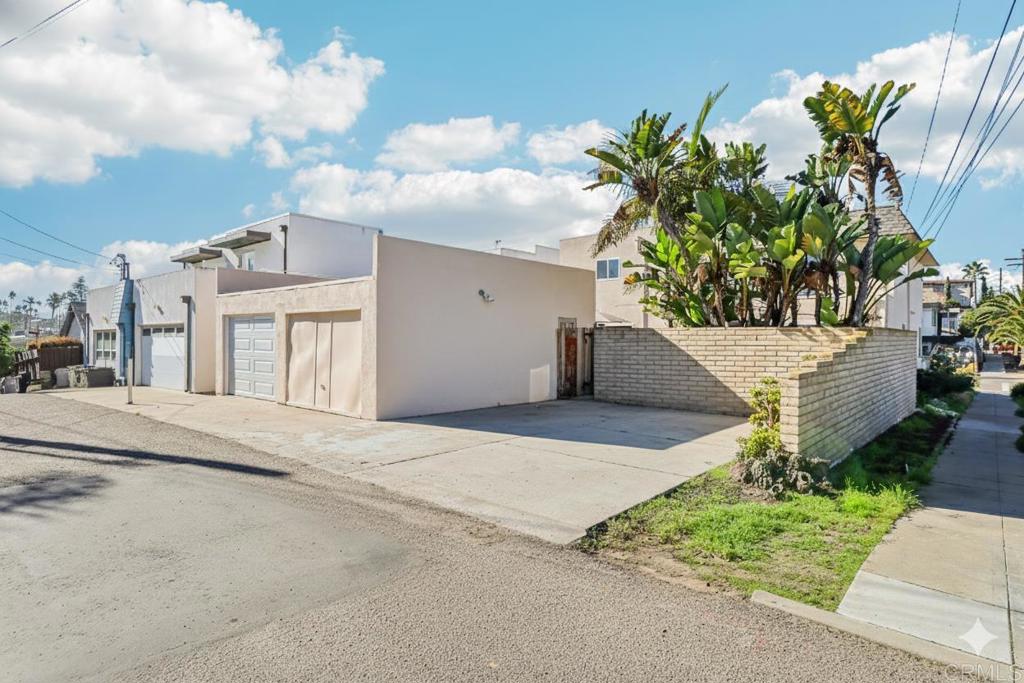 201 4th Street, Unit A/B Encinitas, CA 92024 - Photo 30 of 33 a view of a white house with a yard and potted plants