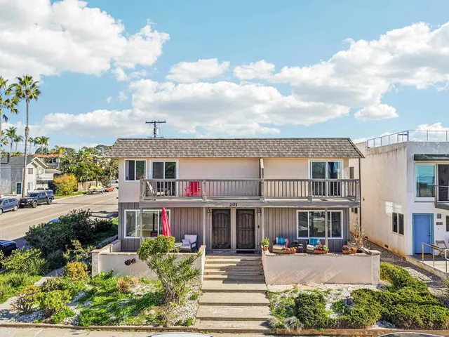 a living room with furniture a table and a large window