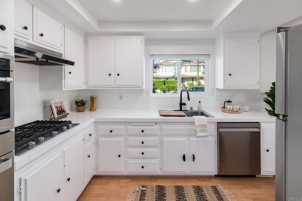201 4th Street, Unit A/B Encinitas, CA 92024 - Photo 9 of 33 a kitchen with cabinets appliances a sink and a window