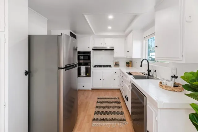 a kitchen with a sink appliances and cabinets