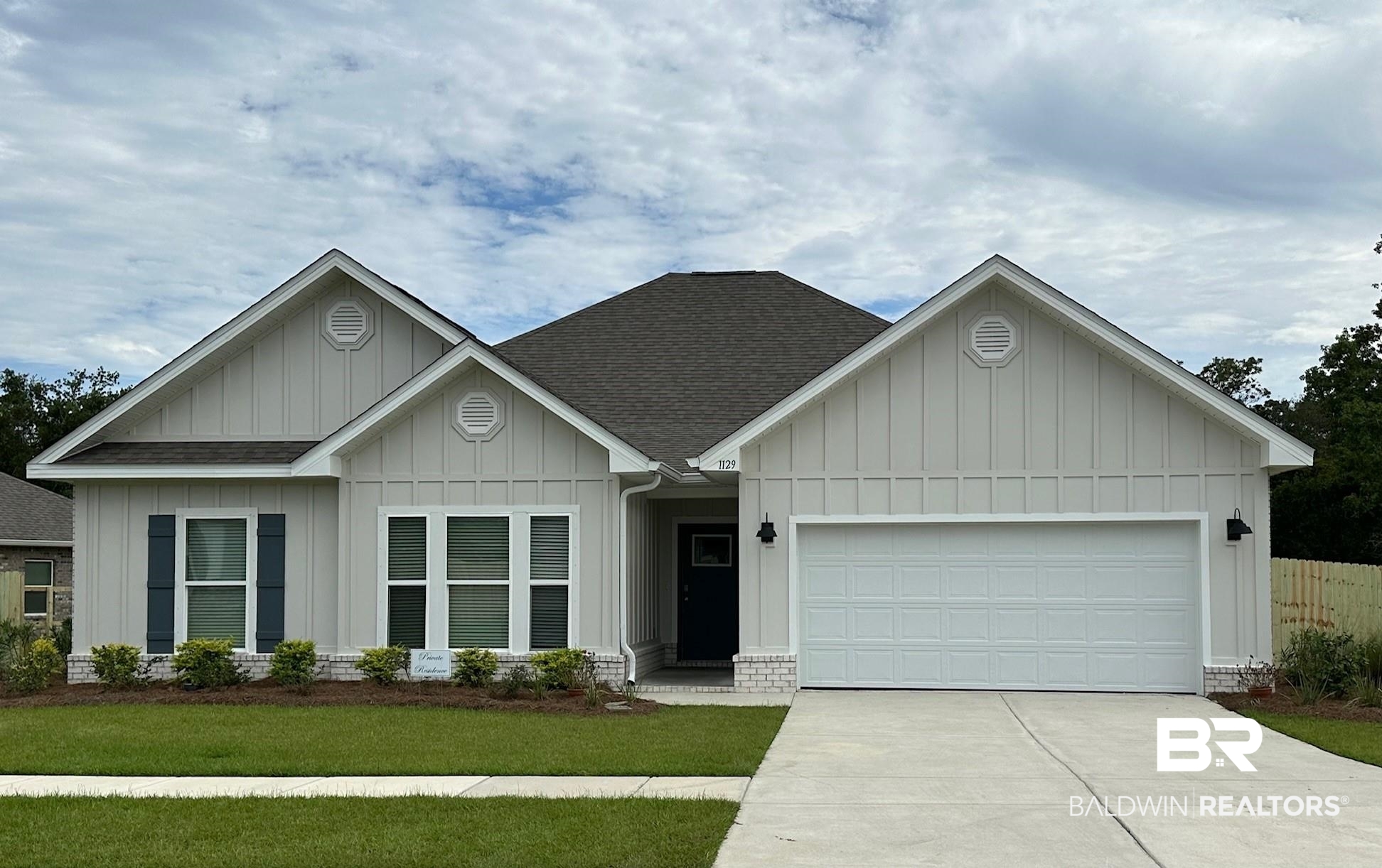 1129 Pencarro Boulevard Foley, AL 36535 - Photo 1 of 18 View of front facade featuring a garage and a front lawn