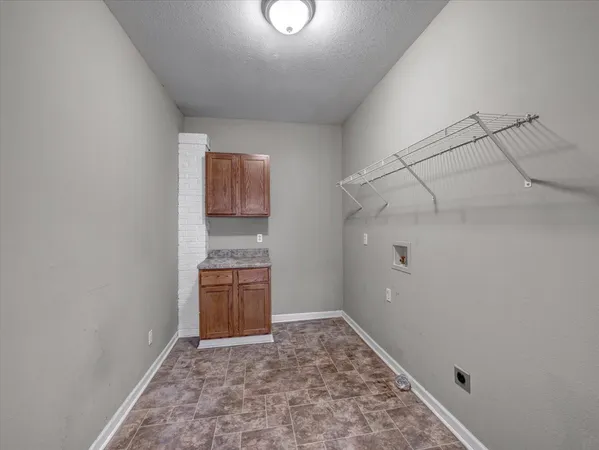 a view of an empty room and cabinet