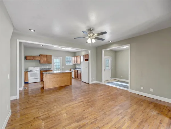 a view of kitchen with cabinets and window