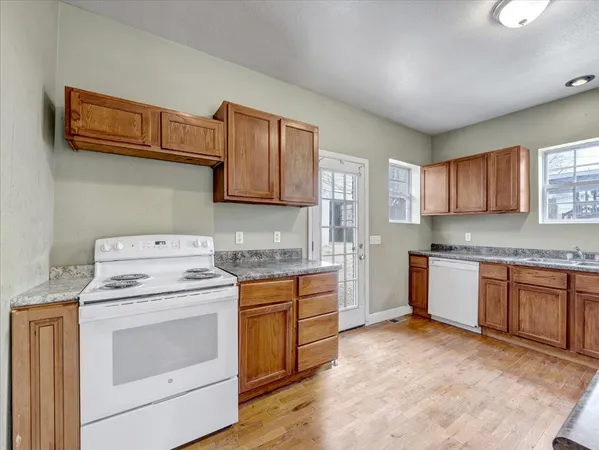a kitchen with a stove top oven sink and cabinets