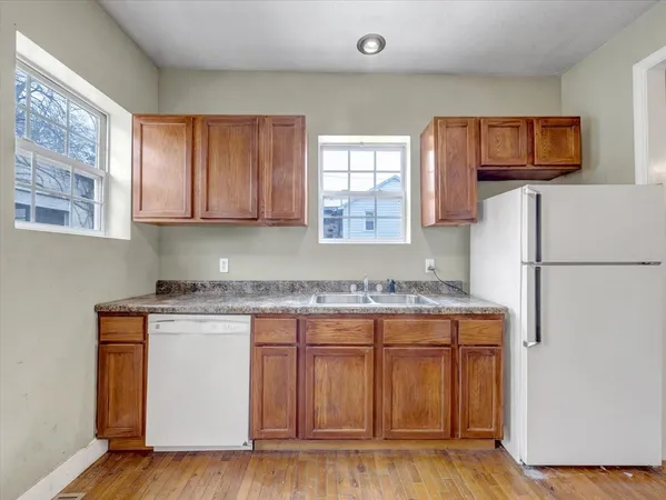 a kitchen with a refrigerator and a stove top oven