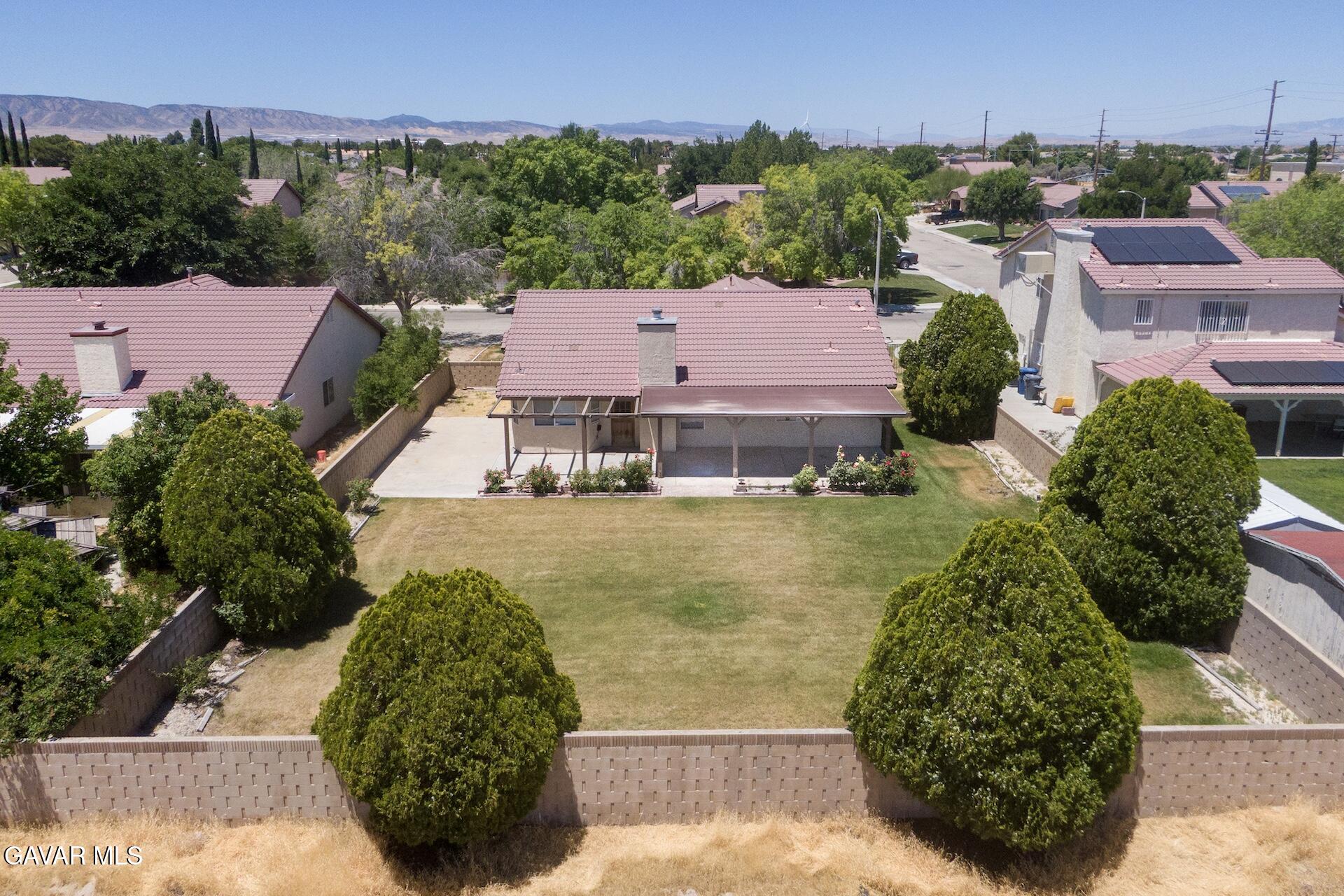 44318 33rd Street West Lancaster, CA 93536 - Photo 2 of 29 an aerial view of residential houses with outdoor space and swimming pool