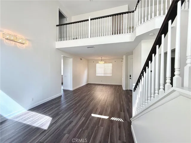 a view of entryway with wooden floor and stairs
