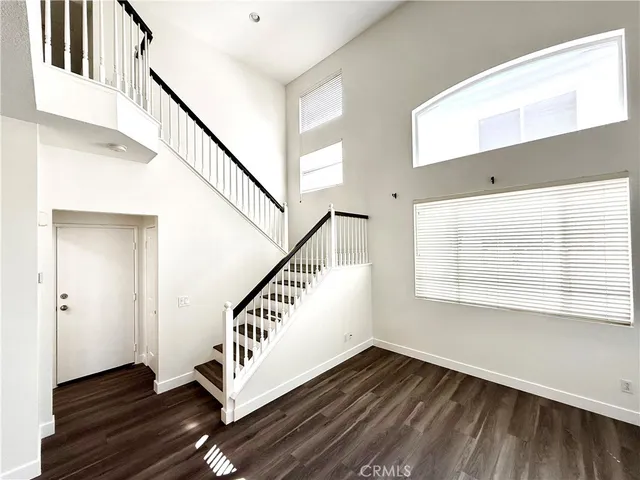 a view of an entryway with wooden floor