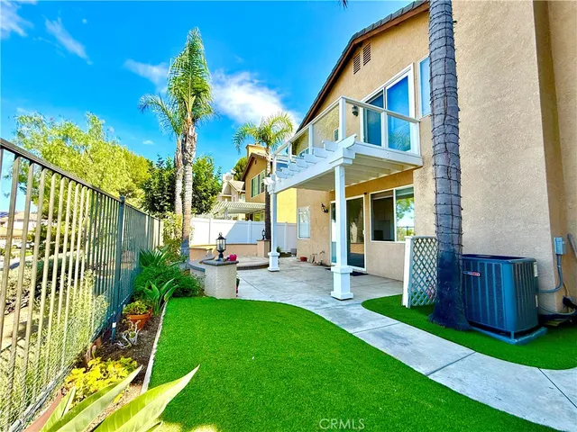 a front view of a house with a yard table and chairs