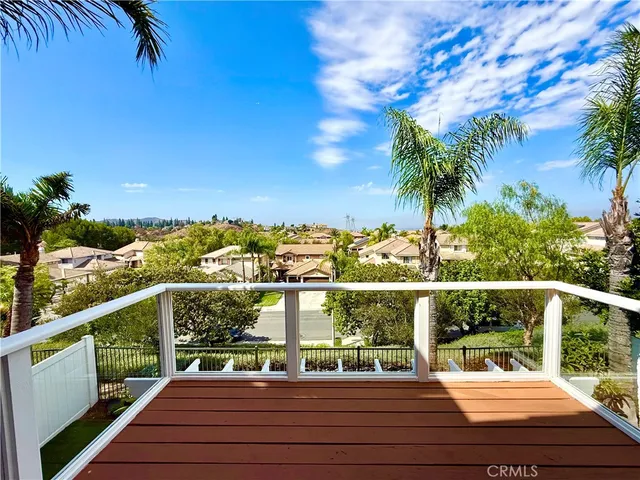 a view of a balcony with wooden floor and outdoor space