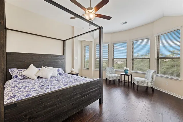 a kitchen with sink stove and white cabinets with wooden floor