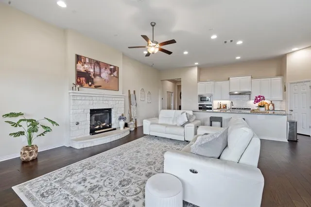 a living room with furniture a fireplace and wooden floor