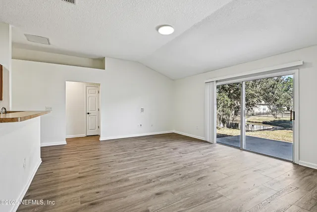 a kitchen with stainless steel appliances granite countertop a stove top oven a refrigerator and a sink with granite countertops