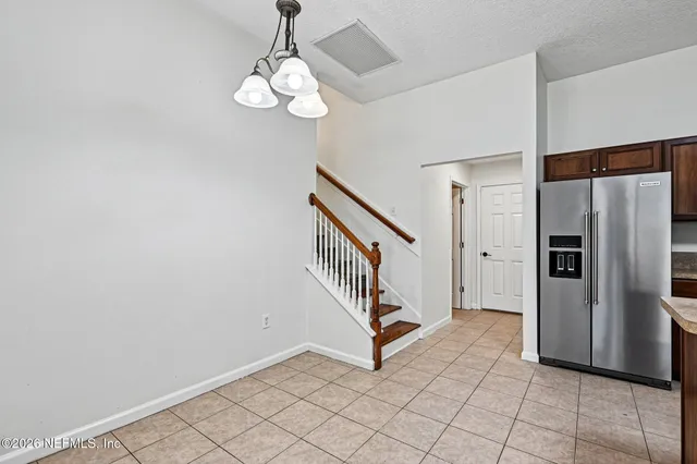 an empty room with wooden floor and window