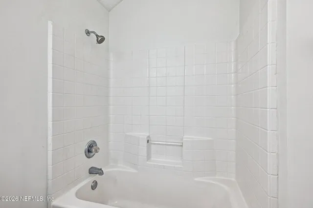 a bathroom with a double vanity sink and mirror with shower
