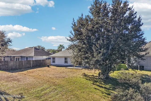 an aerial view of residential houses with city view